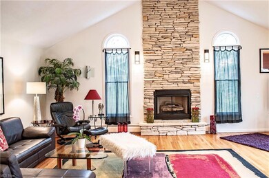 Great room with gas fired stone fireplace and vaul