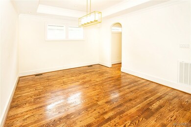 Unfurnished room with a tray ceiling, hardwood / w