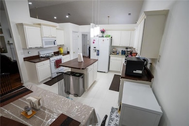 Kitchen with white appliances, a center island, re