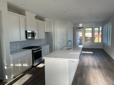 Kitchen with stainless steel appliances, a sink, 