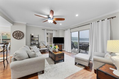 Living room featuring ceiling fan, light wood-style floors, ornamental molding, and recessed lighting