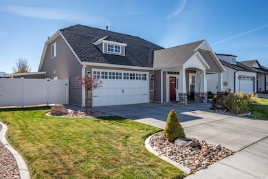 View of front of property with roof with shingles, driveway, a garage, and stone siding