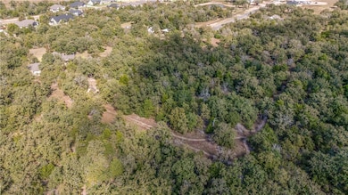 View of property location with a heavily wooded area
