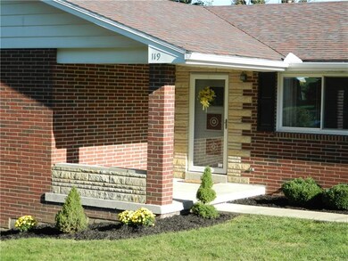 The entry is beautifully accented with a stone sur