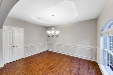 FORMAL DINING ROOM - with beautiful new wood laminate flooring, accent molding and direct access to the kitchen through double of doors.