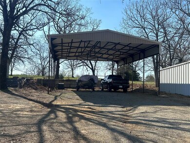 View of parking / parking lot with driveway and a 