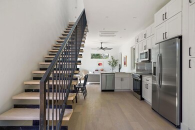 Kitchen featuring white cabinets, light wood-styl