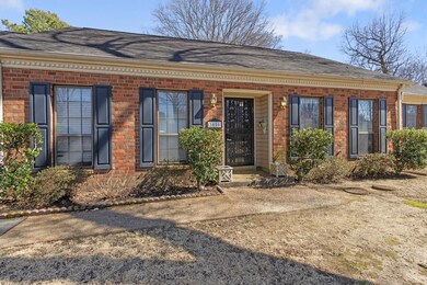 View of exterior entry featuring brick siding and 