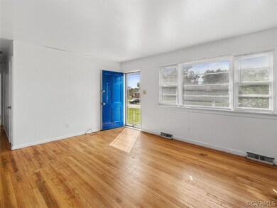 Family Room w/ Hardwood Floors & Windows.