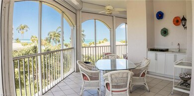 Sunroom featuring a water view, ceiling fan, and p