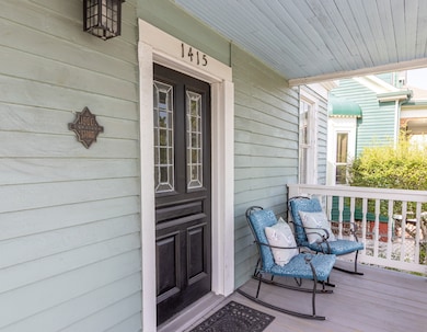 Front door with the 1900 Storm survivor plaque.