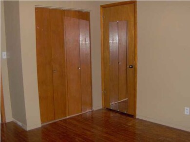 Bedroom has large closet and hardwood floors