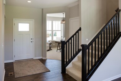 The foyer and flex room, as shown in our former model in Lakeville
