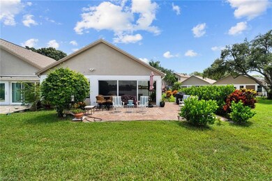 Rear view of property with a yard and a patio area