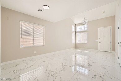 Unfurnished room featuring a chandelier, marble fi