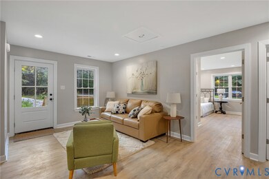 Living room with light wood-style floors and recessed lighting