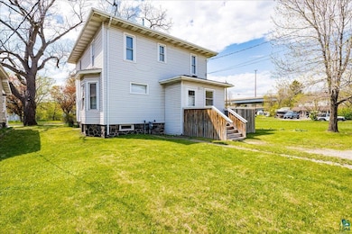 Rear view of house with a yard