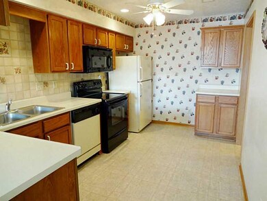 Kitchen. Plenty of cabinets and counter space. Room for small table and chairs. Door on right leads to laundry room and garage.