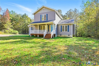 Traditional home with crawl space, covered porch, a front yard, and roof with shingles