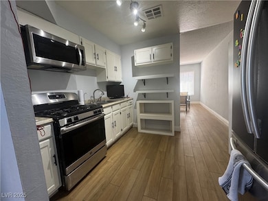 Kitchen featuring light countertops, white cabinet