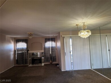 Unfurnished living room with carpet, a textured ce