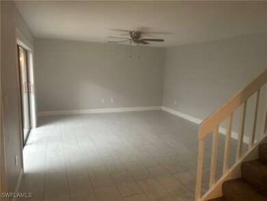 Unfurnished room with a ceiling fan and stairway