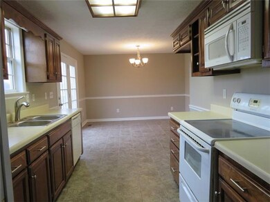 Plenty of space in this kitchen and Dining area with new tile floors, fresh paint and new light fixture