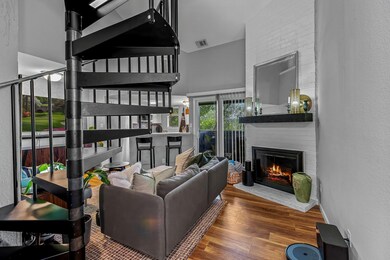 Living room with a towering ceiling, a brick fire