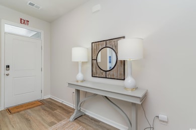Foyer with wood finished floors and baseboards
