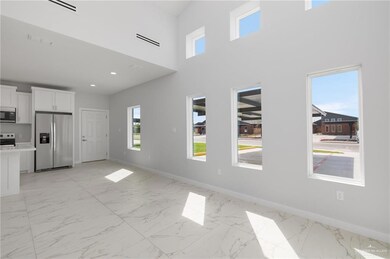 Unfurnished room featuring a towering ceiling