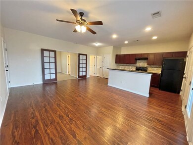 Kitchen with black appliances, under cabinet range