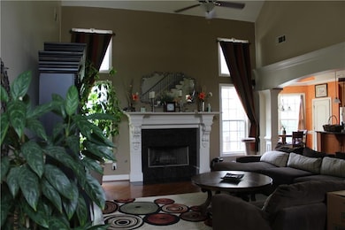 Living room featuring wood finished floors, a fire