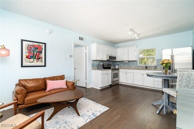 Living area with LVP flooring, midcentury modern f