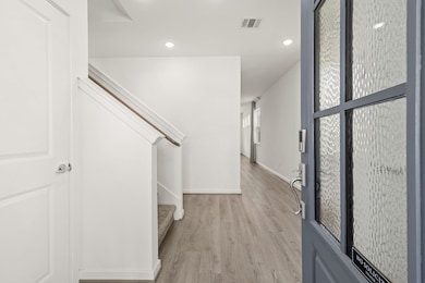 The entry way is bright, open, and features the wood-look flooring that extends through the main living areas making it easy and clean to maintain!