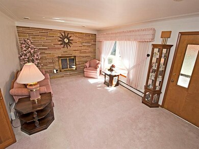 Living room w/ stone gas fireplace updated carpet,