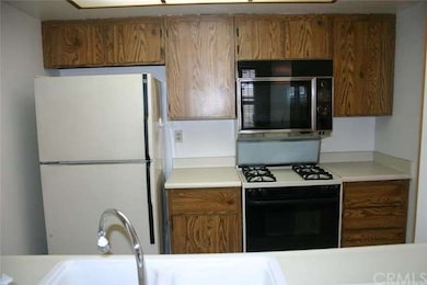 Other side of the kitchen has a range, oven and mi
