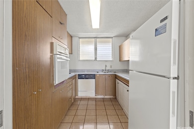The galley-style kitchen offers generous cabinet storage and a functional layout ready for your personal updates.