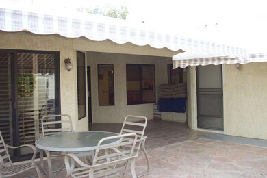 BACK YARD WITH TWO RETRACTABE AWNINGS