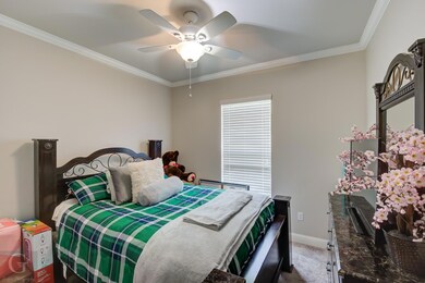 Bedroom featuring carpet, ornamental molding, and 