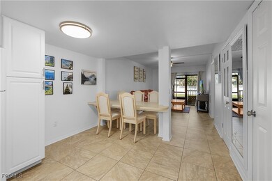 Dining space with light tile patterned floors and ceiling fan