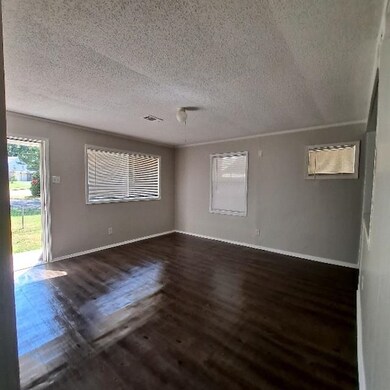 Unfurnished room featuring a textured ceiling and 