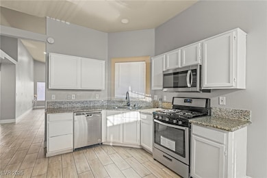 Kitchen featuring stainless steel appliances, a si