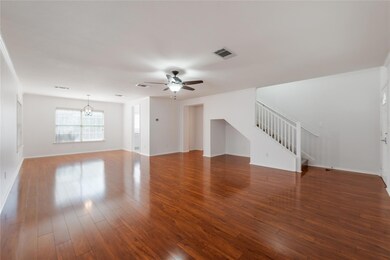 Unfurnished living room featuring stairway, ceili
