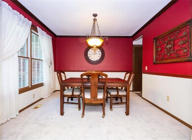 Formal dining room w/newer carpeting, chair rail a