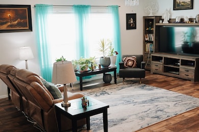 Living area featuring dark wood-style flooring