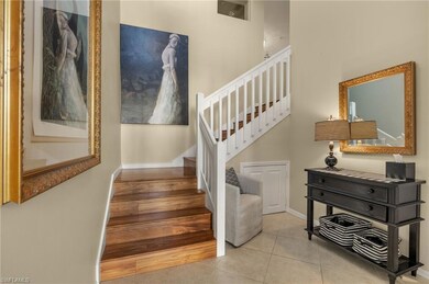 Staircase with tile patterned flooring and baseboa
