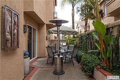 Tropical outdoor area with palm and fruit trees.