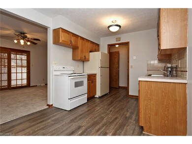 Kitchen with oak cabinetry and new ceramic tile fl