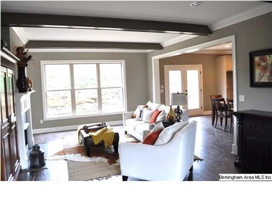 Pretty exposed beams, hardwood flooring and large 