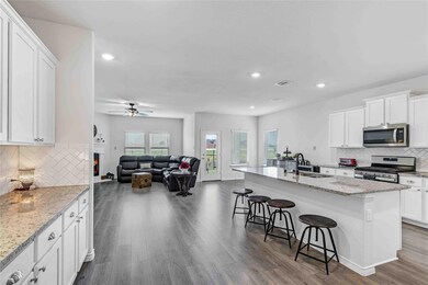 Plenty of cabinets in this home and a large area to the left for a coffee bar or extra entertaining area for food and beverages!